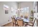 Well-lit dining room showcasing a chandelier and views from multiple windows at 6129 Flaming Arrow Rd, North Las Vegas, NV 89031