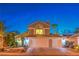 Charming two-story home with a well-manicured front yard and a three car garage at 6129 Flaming Arrow Rd, North Las Vegas, NV 89031