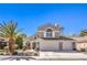Charming two-story home with a well-manicured front yard, three car garage, and ample natural light at 6129 Flaming Arrow Rd, North Las Vegas, NV 89031