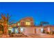 Charming two-story home with a well-manicured front yard and a three car garage at 6129 Flaming Arrow Rd, North Las Vegas, NV 89031