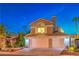 Charming two-story home with a well-manicured front yard and a three car garage at 6129 Flaming Arrow Rd, North Las Vegas, NV 89031