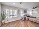 Cozy living room with plantation shutters, ample natural light, comfortable seating, and tile flooring at 6129 Flaming Arrow Rd, North Las Vegas, NV 89031