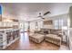 Open-concept living room with modern decor, ceiling fan, and plenty of natural light at 6129 Flaming Arrow Rd, North Las Vegas, NV 89031