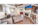 Bright living room featuring a unique ceiling fan, fireplace, tile flooring and comfortable seating at 6129 Flaming Arrow Rd, North Las Vegas, NV 89031