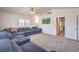 Spacious living room featuring neutral carpet and a comfortable oversized sectional at 6129 Flaming Arrow Rd, North Las Vegas, NV 89031