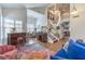Bright, open-concept living area featuring stairs, dining area, and modern lighting at 6129 Flaming Arrow Rd, North Las Vegas, NV 89031