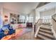 Open-concept living room showcasing staircase, bar, and colorful decor at 6129 Flaming Arrow Rd, North Las Vegas, NV 89031