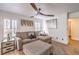 Cozy living room with modern decor, ceiling fan and bright natural light at 6129 Flaming Arrow Rd, North Las Vegas, NV 89031