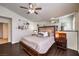 Cozy main bedroom features ceiling fan, plantation shutters, wood floors, and stylish decor at 6129 Flaming Arrow Rd, North Las Vegas, NV 89031