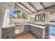 Outdoor kitchen with grill and stone counter top, perfect for entertaining at 6129 Flaming Arrow Rd, North Las Vegas, NV 89031
