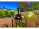 Outdoor space showcasing a pizza oven, firewood storage, and a neon pizza slice sign at 6129 Flaming Arrow Rd, North Las Vegas, NV 89031