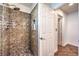 Beautiful granite tiled shower with glass door and neutral tones, adjacent to white doors at 6129 Flaming Arrow Rd, North Las Vegas, NV 89031