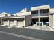 Condo with multiple attached garages, second story units, parking spaces, and landscaped surroundings at 6250 W Flamingo Rd # 143, Las Vegas, NV 89103