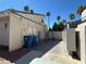 Image shows outdoor mailboxes near trash receptacles, with palm trees in the background, under a clear blue sky at 6250 W Flamingo Rd # 143, Las Vegas, NV 89103