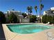 Community pool surrounded by lounge chairs, palm trees, and well-maintained landscaping at 6250 W Flamingo Rd # 143, Las Vegas, NV 89103