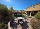 Inviting backyard featuring a brick patio, a cozy fire pit, and green grass under a bright blue sky at 6656 Fort William St, North Las Vegas, NV 89084