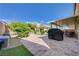 Outdoor patio with brick pavers, a covered grill, green shrubs and a backyard seating area and additional gazebo at 6656 Fort William St, North Las Vegas, NV 89084