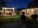 Landscaped backyard with a cozy outdoor lounge area and stone pavers at 6656 Fort William St, North Las Vegas, NV 89084