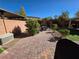 Paved patio with green artificial grass, seating area, and landscaping, ideal for relaxation and outdoor gatherings at 6656 Fort William St, North Las Vegas, NV 89084