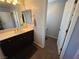 Bathroom featuring a single vanity with a dark wood cabinet and tile flooring at 6656 Fort William St, North Las Vegas, NV 89084