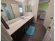 Bathroom with a wide mirror, dark cabinets and a blue rug at 6656 Fort William St, North Las Vegas, NV 89084