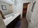 Bathroom features a wide mirror and brown cabinets at 6656 Fort William St, North Las Vegas, NV 89084