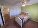 Well-lit bedroom featuring closet, a ceiling fan, and neutral carpet at 6656 Fort William St, North Las Vegas, NV 89084