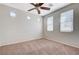 Light-filled bedroom with neutral carpeting, a ceiling fan, and multiple windows for ample sunlight at 6656 Fort William St, North Las Vegas, NV 89084