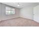 Bedroom featuring a window, blinds, carpet, white walls, and a door at 6656 Fort William St, North Las Vegas, NV 89084