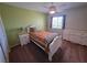 Cozy bedroom with bright green walls, white furniture, and a ceiling fan at 6656 Fort William St, North Las Vegas, NV 89084