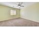 This cozy bedroom includes neutral carpet and a modern ceiling fan at 6656 Fort William St, North Las Vegas, NV 89084