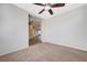 Cozy bedroom with carpet flooring, ceiling fan, and an open doorway leading to other rooms at 6656 Fort William St, North Las Vegas, NV 89084