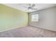 Bedroom with carpet, white walls, green accent wall and a window at 6656 Fort William St, North Las Vegas, NV 89084