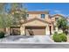 Beautiful two-story home with a three-car garage and a well-maintained front yard at 6656 Fort William St, North Las Vegas, NV 89084