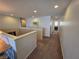 Carpeted upstairs hallway showing railing overlooking lower level at 6656 Fort William St, North Las Vegas, NV 89084