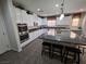 Kitchen featuring white cabinets, granite countertops, stainless steel appliances and large kitchen island at 6656 Fort William St, North Las Vegas, NV 89084