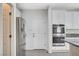 Kitchen with stainless steel refrigerator and double ovens near a door to a mudroom or pantry at 6656 Fort William St, North Las Vegas, NV 89084