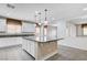 Kitchen island with bar stool seating, pendant lighting, and stainless steel appliances at 6656 Fort William St, North Las Vegas, NV 89084