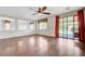 Open living room with hardwood floors, natural light, and sliding glass doors leading to the outside at 6656 Fort William St, North Las Vegas, NV 89084