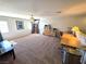 Large carpeted loft featuring a ceiling fan, built in desk, and a large window at 6656 Fort William St, North Las Vegas, NV 89084