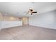 Open loft area with neutral carpeting, a ceiling fan, and a view of the upstairs hallway at 6656 Fort William St, North Las Vegas, NV 89084