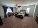 Spacious main bedroom featuring a ceiling fan and natural light from the windows at 6656 Fort William St, North Las Vegas, NV 89084