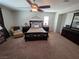 This main bedroom offers a cozy seating area, dresser, and a large comfy bed at 6656 Fort William St, North Las Vegas, NV 89084