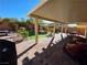 Comfortable covered patio with brick flooring and lounge seating, perfect for relaxation and outdoor enjoyment at 6656 Fort William St, North Las Vegas, NV 89084