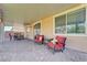 Covered patio area features outdoor seating and dining areas with views of the backyard and landscaped yard at 6656 Fort William St, North Las Vegas, NV 89084