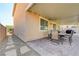 Covered patio features an outdoor dining set and stone pavers at 6656 Fort William St, North Las Vegas, NV 89084