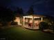 Backyard pergola seating area with ambient lighting on a brick patio at 6656 Fort William St, North Las Vegas, NV 89084