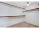 Spacious walk-in closet features shelving, carpet, and a ceiling fan at 6656 Fort William St, North Las Vegas, NV 89084