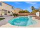 Beautiful backyard with a sparkling pool, spa, and lush greenery at 7078 Seabirds Pl, North Las Vegas, NV 89084