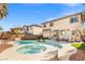 Backyard features a sparkling pool, spa, and cozy seating area at 7078 Seabirds Pl, North Las Vegas, NV 89084